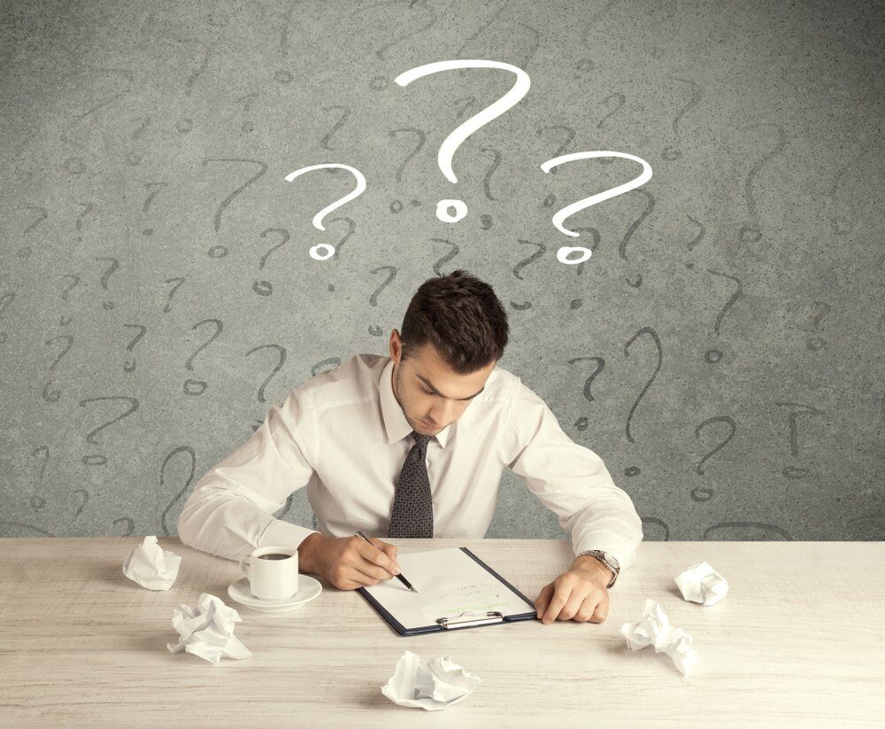 A confused busy elegant office worker in trouble with illustrated question marks concept