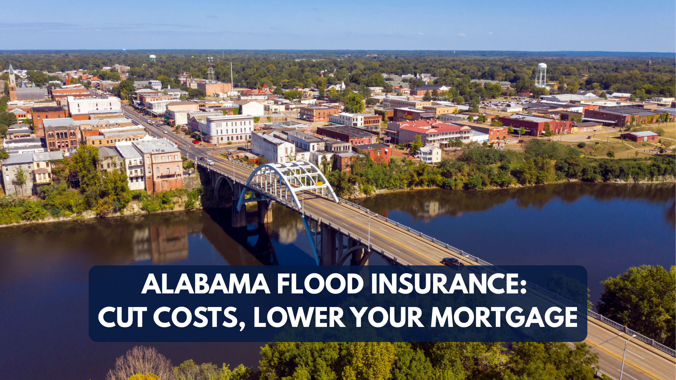 Aerial view of downtown Alabama city with bridge over river, promoting flood insurance savings with text overlay: 