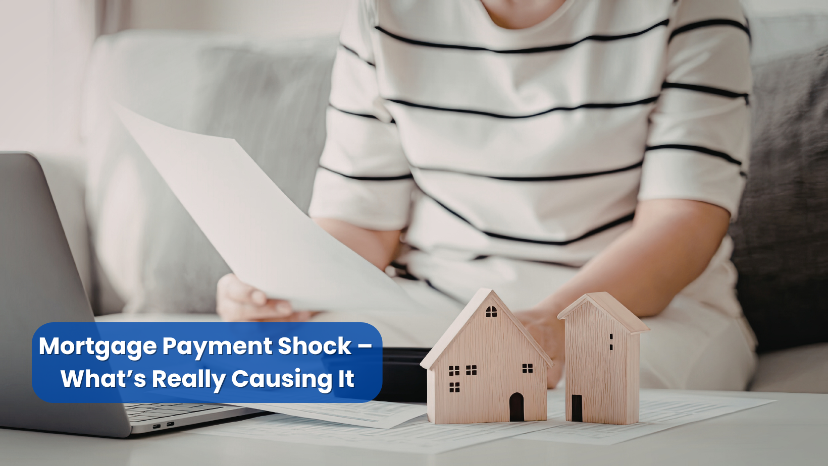 Homeowner reviewing mortgage and insurance documents after payment increase