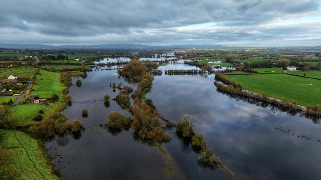 Aerial view of widespread flooding across farmland with rivers overflowing into surrounding land
