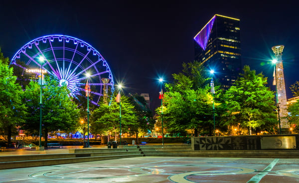Ferris wheel and buildings seen from Olympic Centennial Park at night in Atlanta, Georgia.