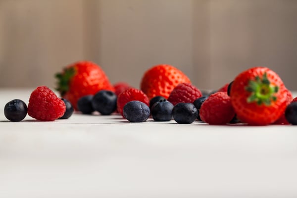 Fresh berries in close up on wooden table