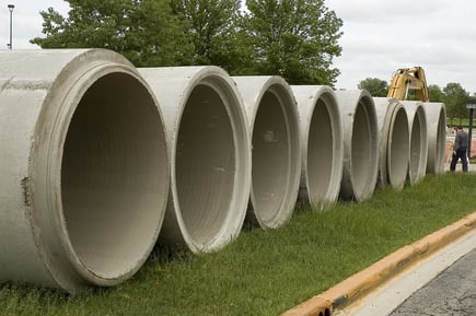Row of concrete conduits on construction site