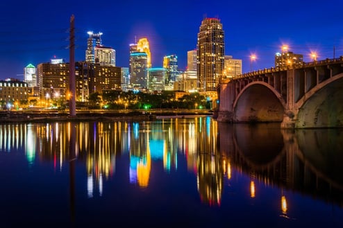 The Central Avenue Bridge and skyline reflecting in the Mississippi River at night, in Minneapolis, Minnesota.