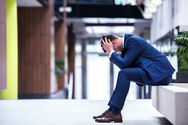 frustrated young business man working on laptop computer at office