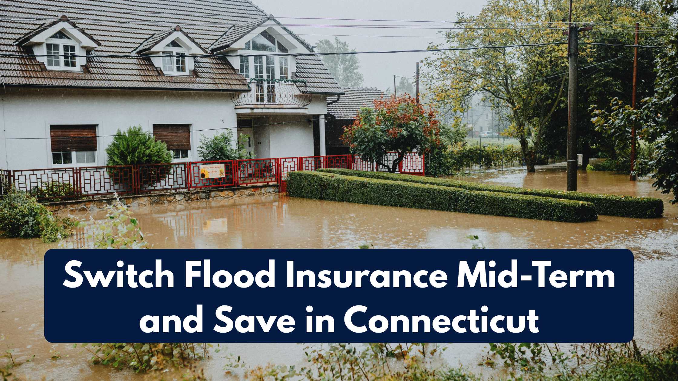 Flooded residential neighborhood in Connecticut with water surrounding a house, illustrating the need for switching flood insurance mid-term to save money.