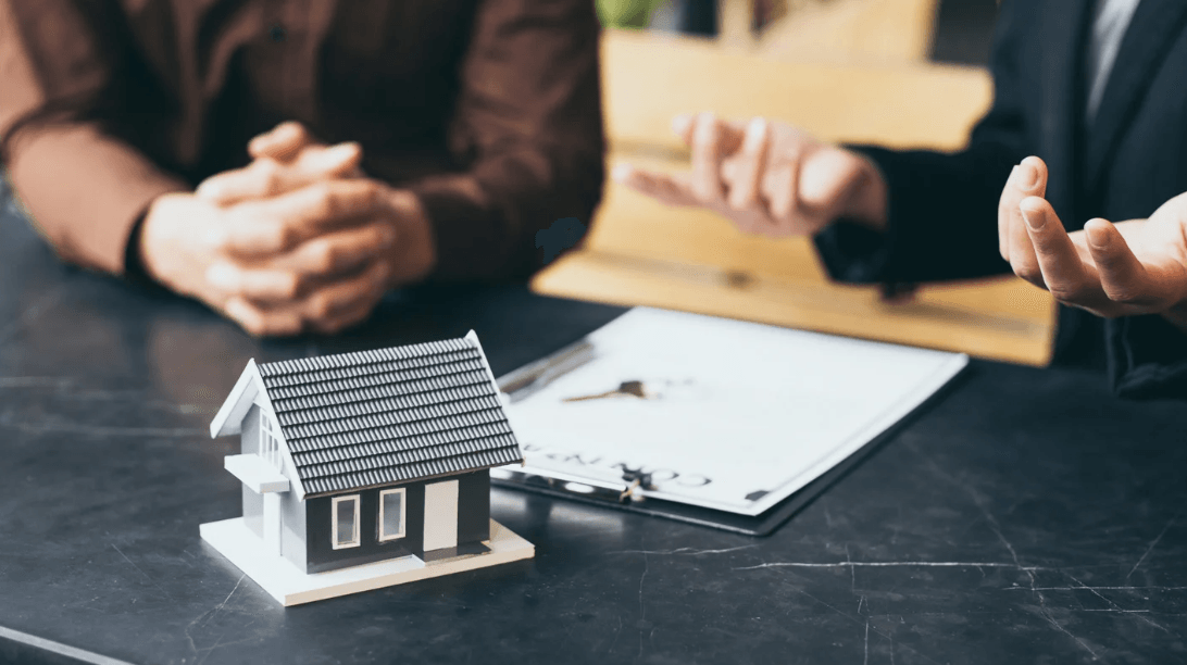 two persons discussing a real estate sale